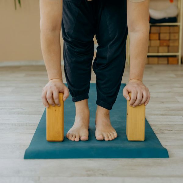 Person stretching on a yoga mat showing flexibility and energy.